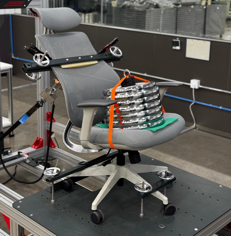 An OmniSit Pro chair on a laboratory load rig with test weights
