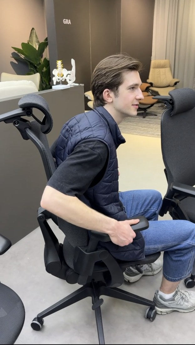Gustas trying a chair at a furniture fair
